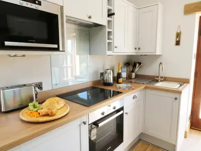 a kitchen with a plate of food on a counter at Sunnybrook Cottage in Clitheroe