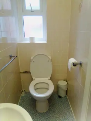 a small bathroom with a toilet and a window at The braeside families and couples in Blackpool