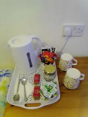 a counter with a blender and utensils on a tray at The braeside families and couples in Blackpool