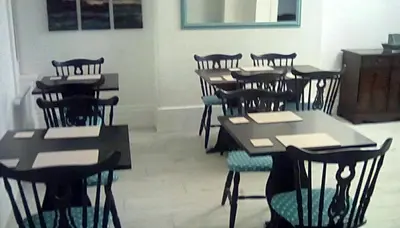 a group of tables and chairs in a room at The braeside families and couples in Blackpool