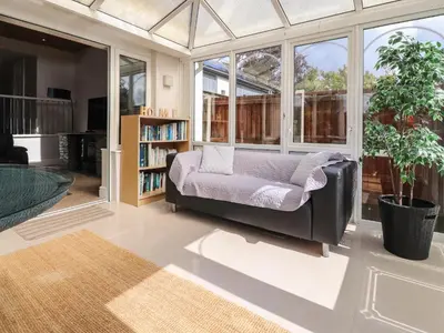 a living room with a couch and a book shelf at Palm Court in Carnforth