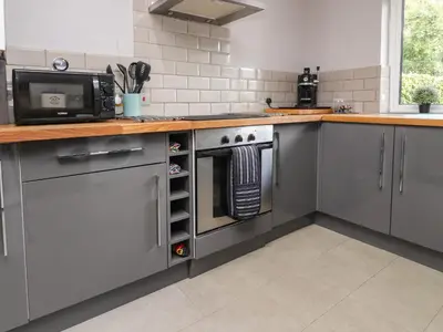 a kitchen with stainless steel appliances and a microwave at Palm Court in Carnforth