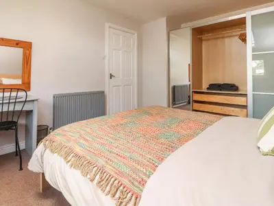 a bedroom with a bed and a desk and a window at Palm Court in Carnforth