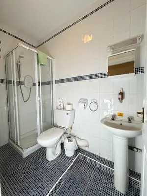 a bathroom with a toilet and a sink at Rossdene House in Blackpool