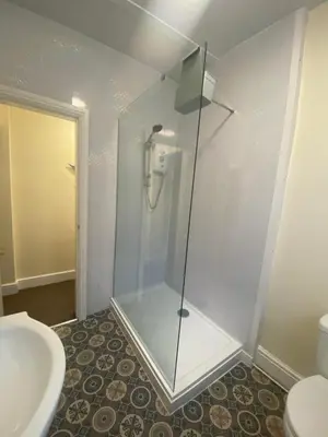 a glass shower in a bathroom with a toilet at The Hurstmere in Blackpool
