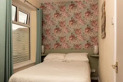a small bedroom with a bed and a window at The Hurstmere in Blackpool
