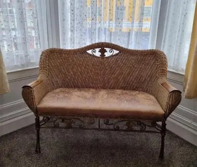 a brown couch sitting in front of a window at Sirocco Blues Guest House in Blackpool