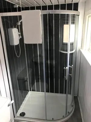 a shower with a glass door in a bathroom at Sirocco Blues Guest House in Blackpool