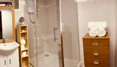 a bathroom with a shower and a sink at Danescourt Lodge in Blackpool
