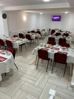 a dining room with tables and chairs and a tv at Danescourt Lodge in Blackpool
