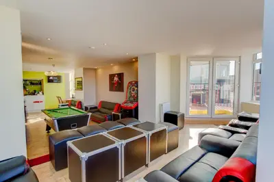 a living room with couches and a pool table at New Promenade Hotel in Blackpool