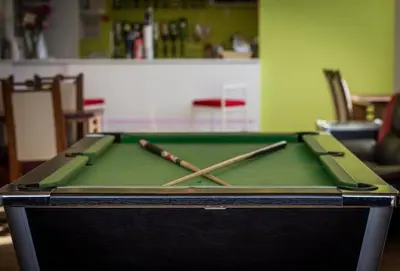 a pool table with two cuesticks on top of it at New Promenade Hotel in Blackpool