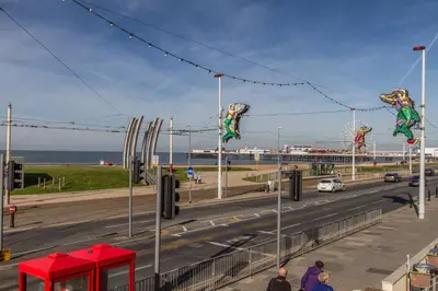 a view of a road with people walking on a bridge at New Promenade Hotel in Blackpool