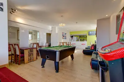 a living room with a pool table and a game room at New Promenade Hotel in Blackpool