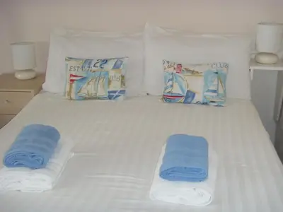 a bed with two towels and pillows on it at Bamford House Hotel in Blackpool