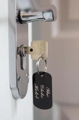 a lock with a key in a door at The Glebe Hotel in Liverpool