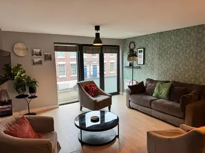 a living room with a couch and a table at Centrally located apartment in Duke Street- free parking- two bathrooms in Liverpool