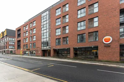 an empty street in front of a brick building at Centrally located apartment in Duke Street- free parking- two bathrooms in Liverpool