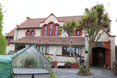 a house with a glass greenhouse in front of it at Victoria House in Barrow in Furness