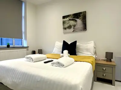 a bedroom with a bed with a teddy bear on it at Winter Gardens Service Apartments 2 by Blackpool Service Apartments in Blackpool