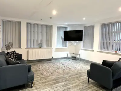 a living room with two couches and a flat screen tv at Winter Gardens Service Apartments 2 by Blackpool Service Apartments in Blackpool