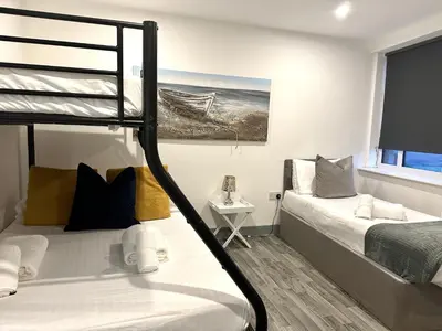 a bedroom with two bunk beds and a window at Winter Gardens Service Apartments 2 by Blackpool Service Apartments in Blackpool