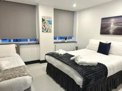 a bedroom with two beds with towels on them at Winter Gardens Service Apartments 2 by Blackpool Service Apartments in Blackpool