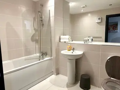 a bathroom with a sink and a toilet and a shower at Winter Gardens Service Apartments 2 by Blackpool Service Apartments in Blackpool