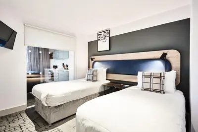 a hotel room with two beds and a tv at Citadines City Centre Liverpool in Liverpool