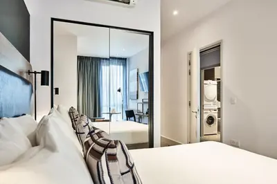 a bedroom with two beds and a mirror at Citadines City Centre Liverpool in Liverpool