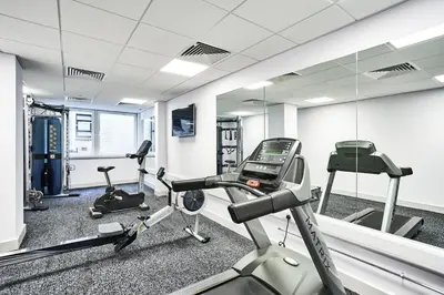a gym with two exercise bikes and a mirror at Citadines City Centre Liverpool in Liverpool