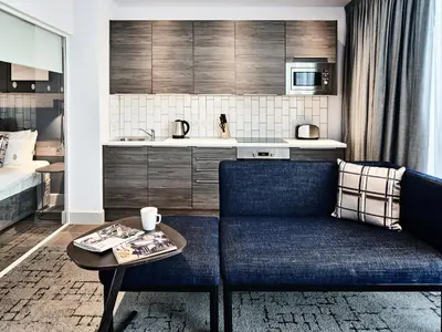 a living room with a couch and a table at Citadines City Centre Liverpool in Liverpool