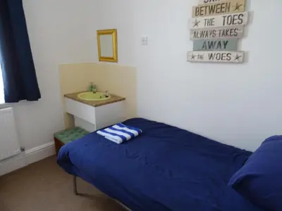 a bedroom with a bed and a sink at Glendowie Hotel in Blackpool