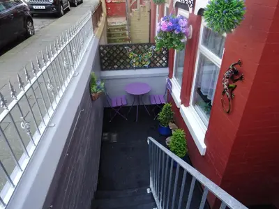a balcony of a building with a table and a window at Glendowie Hotel in Blackpool