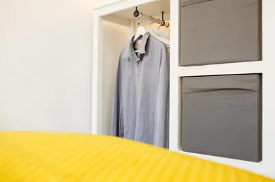 a closet with a blue shirt hanging in a door at Sapphire Home Stay in Liverpool