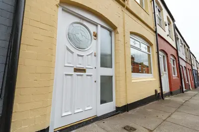 a white door on the side of a building at Sapphire Home Stay in Liverpool