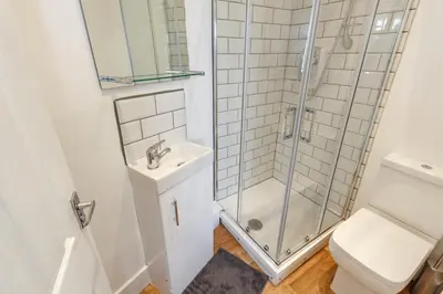 a bathroom with a shower and a toilet and a sink at Sapphire Home Stay in Liverpool