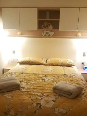 a bed in a bedroom with two pillows on it at Rydal 38 Haven lakeland LA11 7LT in Flookburgh