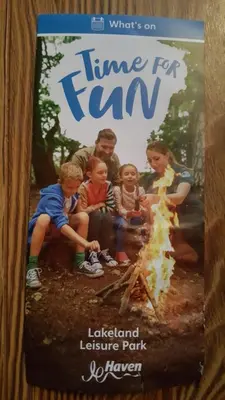 a book about a family sitting around a campfire at Rydal 38 Haven lakeland LA11 7LT in Flookburgh