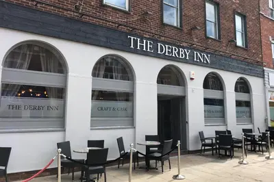 a restaurant with tables and chairs in front of a building at The Derby Hotel in Barrow in Furness