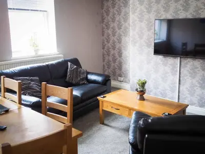 a living room with a couch and a table at The Derby Hotel in Barrow in Furness