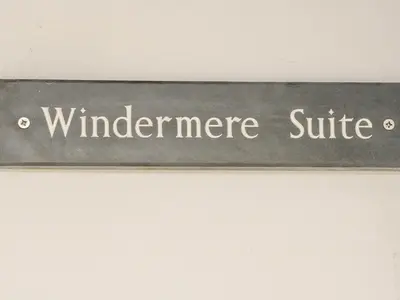a sign that reads windermere suite on a wall at Ellie's Lodge in Ulverston