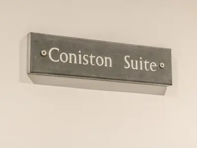 a sign that reads confusion suite hanging on a wall at Ellie's Lodge in Ulverston