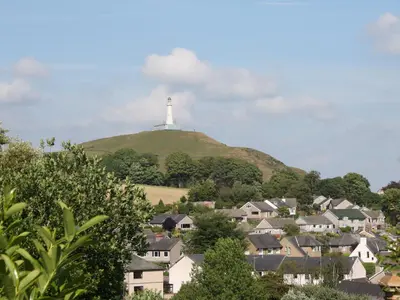a lighthouse on top of a hill with houses at Ellie's Lodge in Ulverston
