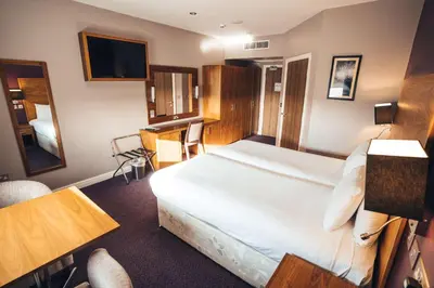 a hotel room with a bed and a desk at Blackpool Football Club Stadium Hotel, a member of Radisson Individuals in Blackpool