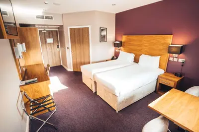 a hotel room with a bed and a desk at Blackpool Football Club Stadium Hotel, a member of Radisson Individuals in Blackpool