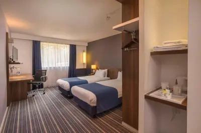 a hotel room with two beds and a desk at Holiday Inn Express Preston South by IHG in Preston