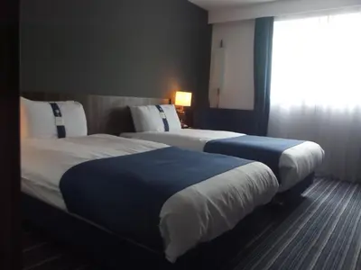a hotel room with two beds and a window at Holiday Inn Express Preston South by IHG in Preston