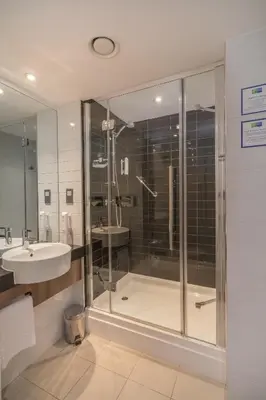 a bathroom with a shower and a sink at Holiday Inn Express Preston South by IHG in Preston