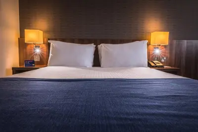 a large bed with white pillows in a hotel room at Holiday Inn Express Preston South by IHG in Preston